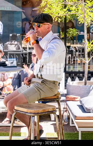 A Young Man Sitting Outside A Cafe During The Art Deco Festival In Napier, Hawke's Bay, New Zealand Stock Photo