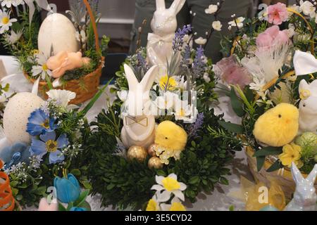 Easter composition with wreaths, bunnies, and decorated eggs, festive spring arrangement horizontal photo Stock Photo