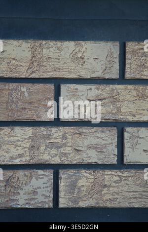 A decorative facing material that imitates brick or stone, which is often used for interior decoration. Vertical photo Stock Photo