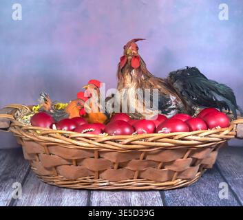Chickens with red eggs in the basket. Stock Photo