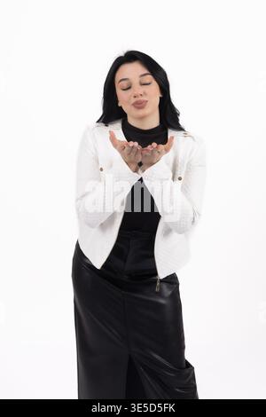 Young woman holding hands near face in studio Stock Photo