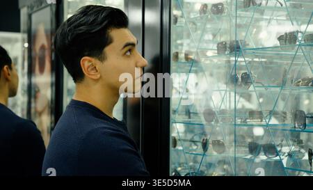 Young man looking at eyeglasses in a shop Stock Photo