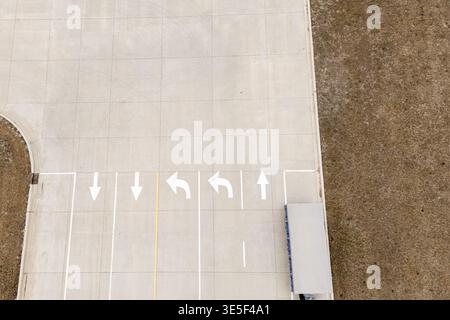 Top down view of road markings and white arrows Stock Photo