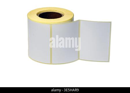 A roll of self-adhesive white labels on a liner, designed for thermal barcode printers, shipping logistics, and inventory labeling on a white backgrou Stock Photo