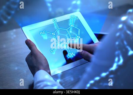 Scientist using tablet computer at table in laboratory, closeup. Skeletal formula above device. Biochemistry research Stock Photo