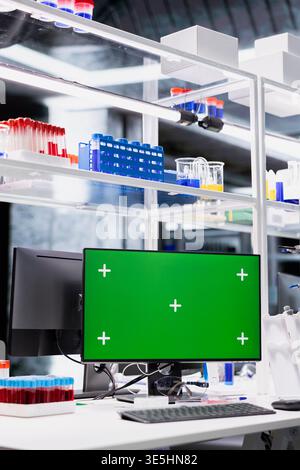 Green screen monitor in research facility workplace used for DNA data molecular analysis. Mockup PC display used for bioinformatics genomics visualization in laboratory environment Stock Photo
