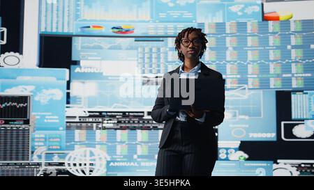 Business professional using laptop to review performance dashboards metrics during corporate strategy planning session. Manager evaluating annual report data using notebook software, camera A Stock Photo