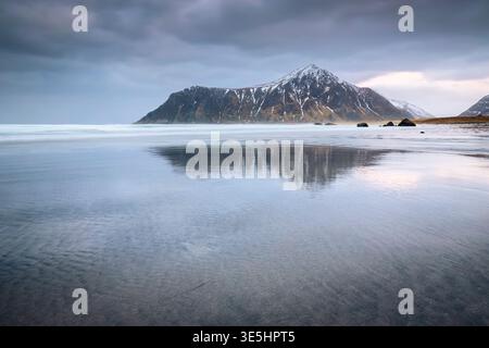 View of a small torrent on the beach of Skagsanden in winter. Skagsanden beach, Flakstad, Lofoten Islands, Norway, Europe. Stock Photo