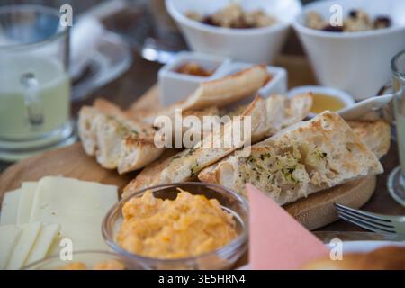 Breakfast Board With Sliced Baguette, Cheese And Spreads On Wooden Board, Fishermans Trail Portugal. Stock Photo