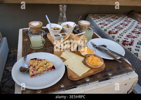Outdoor Breakfast Table With Pastries, Cheeses, Jam-Topped Slice And Coffee On Fishermans Trail, Portugal Stock Photo