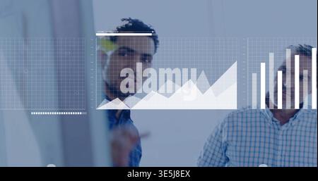 Pointing analyst writing on glass board in meeting room, with charts, sticky note, checked shirt Stock Photo