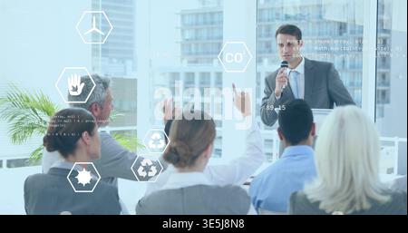 Speaking presenter in suit holding mic at lectern in meeting room with data overlays, copy space Stock Photo