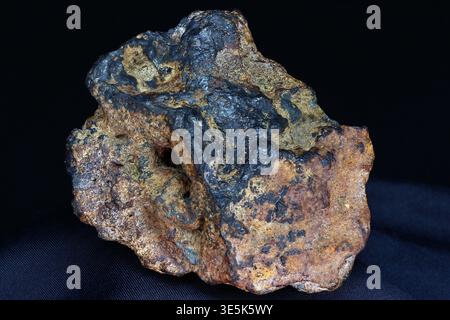Striking closeup of a rough limonite-goethite-hematite specimen from Kaluga region, Russia, featuring rich earthy tones and dark metallic patches Stock Photo