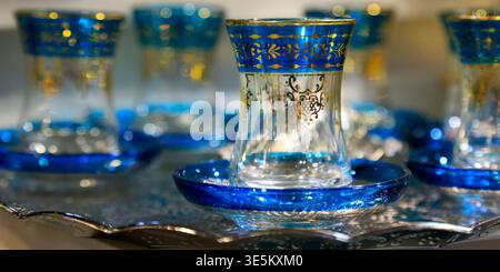 Ornate blue and gold Turkish tea glasses on silver tray, Istanbul, Turkey Stock Photo