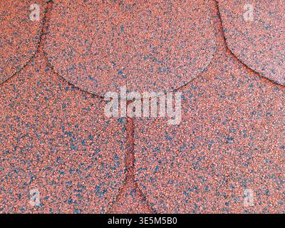 Red bitumen shingles (flexible shingles) used as roofing. Close-up Stock Photo