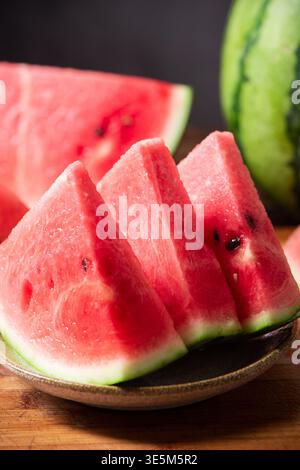 Red watermelon slices with seeds on a plate Stock Photo