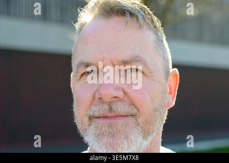 Portrait of a mature man looking into the distance in natural outdoor sunlight. Stock Photo