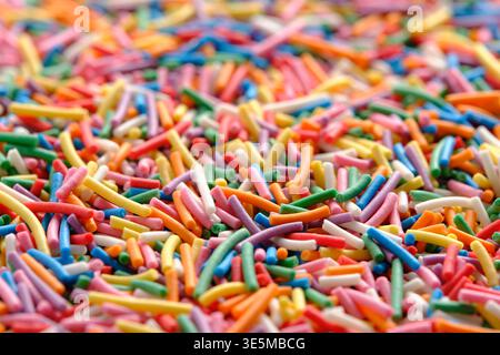 Extreme close up rainbow sugar vermicelli, highlighting shape, colors, and matte texture each sprinkle Stock Photo