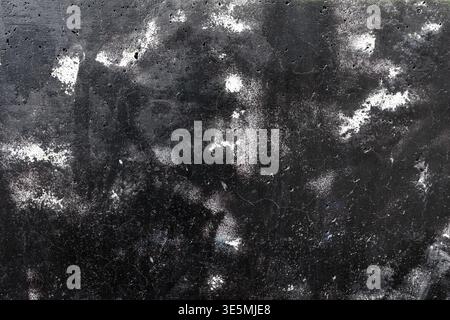 Black Spray Paint on Grungy Concrete Wall with White Splatters Stock Photo