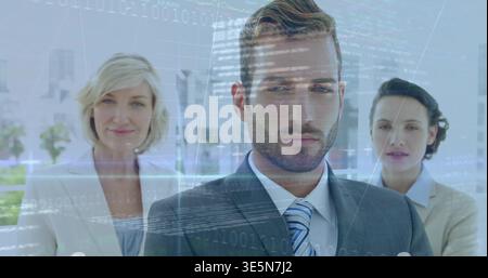 Standing bearded man wearing dark suit and striped tie in corporate lobby, data overlays projecting Stock Photo
