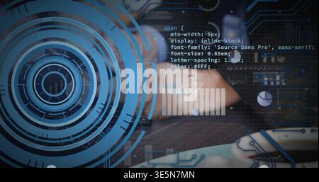 Typing male hands wearing dark jacket using laptop keyboard and touchpad at desk with HUD overlays Stock Photo