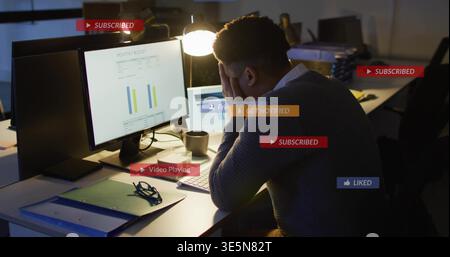 Leaning analyst in dark sweater analyzing charts on 2 monitors at office, notifications, copy space Stock Photo