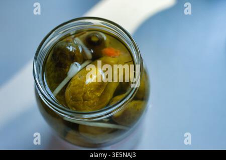 An open jar of pickled cucumbers, top view Stock Photo