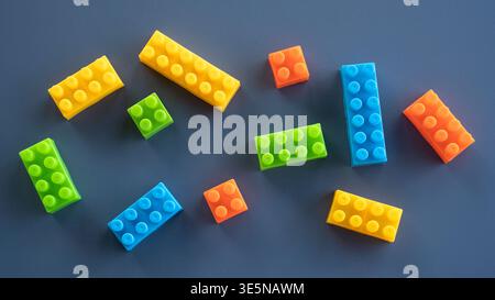 Overhead View of Scattered Multicolored Toy Bricks for Children Education Stock Photo