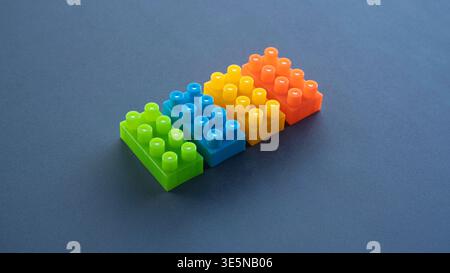 Diagonal Line of Green Blue Yellow and Orange Building Blocks Stock Photo