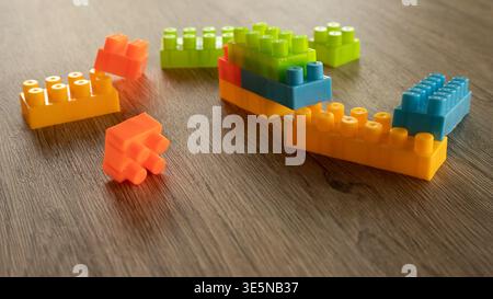 Creative Construction of Stacked Plastic Blocks on Wooden Surface Background Stock Photo