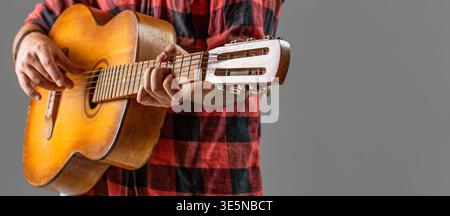 Playing an acoustic guitar. Guitarist hands and guitar. Man's hands playing acoustic guitar, close up. Acoustic guitars playing. Guitarist on stage Stock Photo