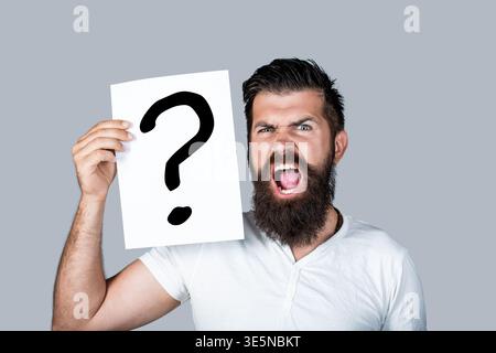 Paper notes with question marks. Confused male thinking with question mark. Scream man with question mark. Doubtful man asking questions to himself Stock Photo