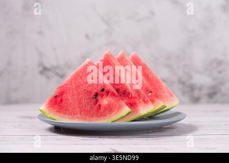 Watermelon slices arranged on a plate, ready for a healthy summer snack Stock Photo