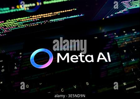 Paris, France. 1st April, 2026. Meta AI logo on a smartphone placed on a laptop keyboard with colorful code overlays, showcasing AI in programming Stock Photo