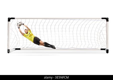 Goalkeeper jumping to catch a football in front of a goal isolated on white background Stock Photo