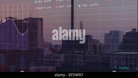 Showing dusk skyline with smokestack through office glass, displaying overlaid financial charts Stock Photo