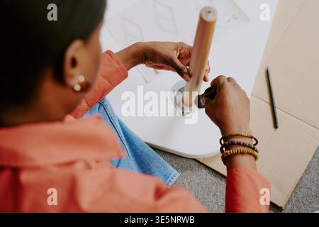 Black Woman Assembling Furniture at Home for Diy Lifestyle Concept Stock Photo