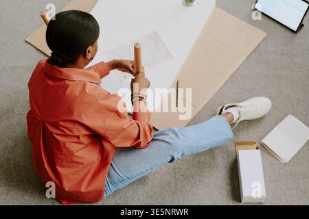 Black Woman Packaging Product Box for Small Business Shipping Stock Photo