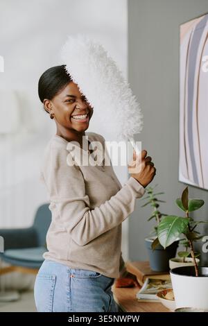 Portrait of Black Woman Cleaning Home for Household Chore Concept Stock Photo