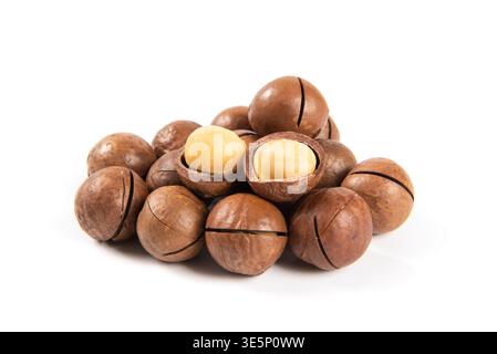 Macadamia nuts displaying whole and shelled kernels on a white background Stock Photo