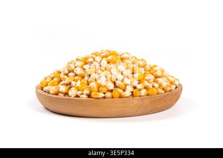 Dried corn kernels filling a wooden bowl isolated on white Stock Photo