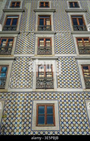 Patterns of Windows on an abandoned Portuguese tiled building in Lisbon Portugal Stock Photo