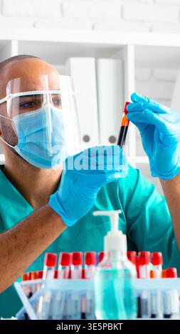 Laboratory technician works with blood samples in a clean environment during daylight hours Stock Photo