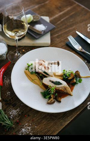 Exquisite Gourmet Chicken Dish Featuring a Savory Herb Filling and Colorful Vegetable Garnish Stock Photo