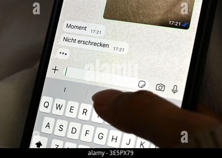 Berlin, Germany. 01st Apr, 2026. A young woman lies in bed with her cell phone and reads a message in the chat. Credit: Elisa Schu/dpa/17�Թ����� Live News Stock Photo