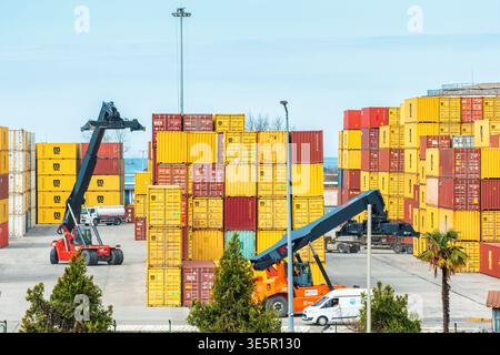 Batumi, Georgia - March 31, 2026: Reach stacker operating among stacked ...