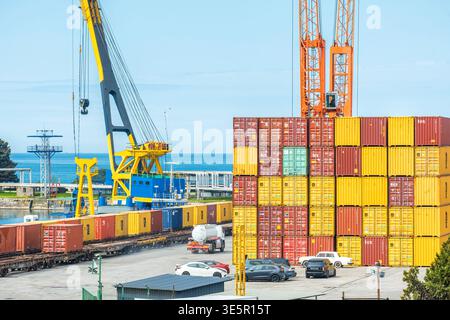 Batumi, Georgia - March 31, 2026: Reach stacker operating among stacked ...