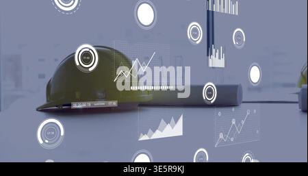 Showing yellow hard hat resting on planning workspace table with rolled plans and HUD graphics Stock Photo