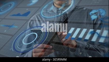Holding tablet male wearing collared shirt and tie interacting at desk with holographic UI Stock Photo