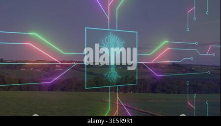 Glowing cyan square with circuit-tree hovering over rural fields, magenta and green traces Stock Photo